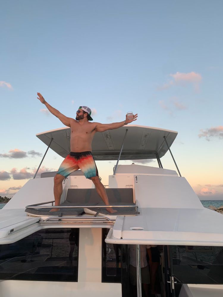 Tom on a boat at sunset