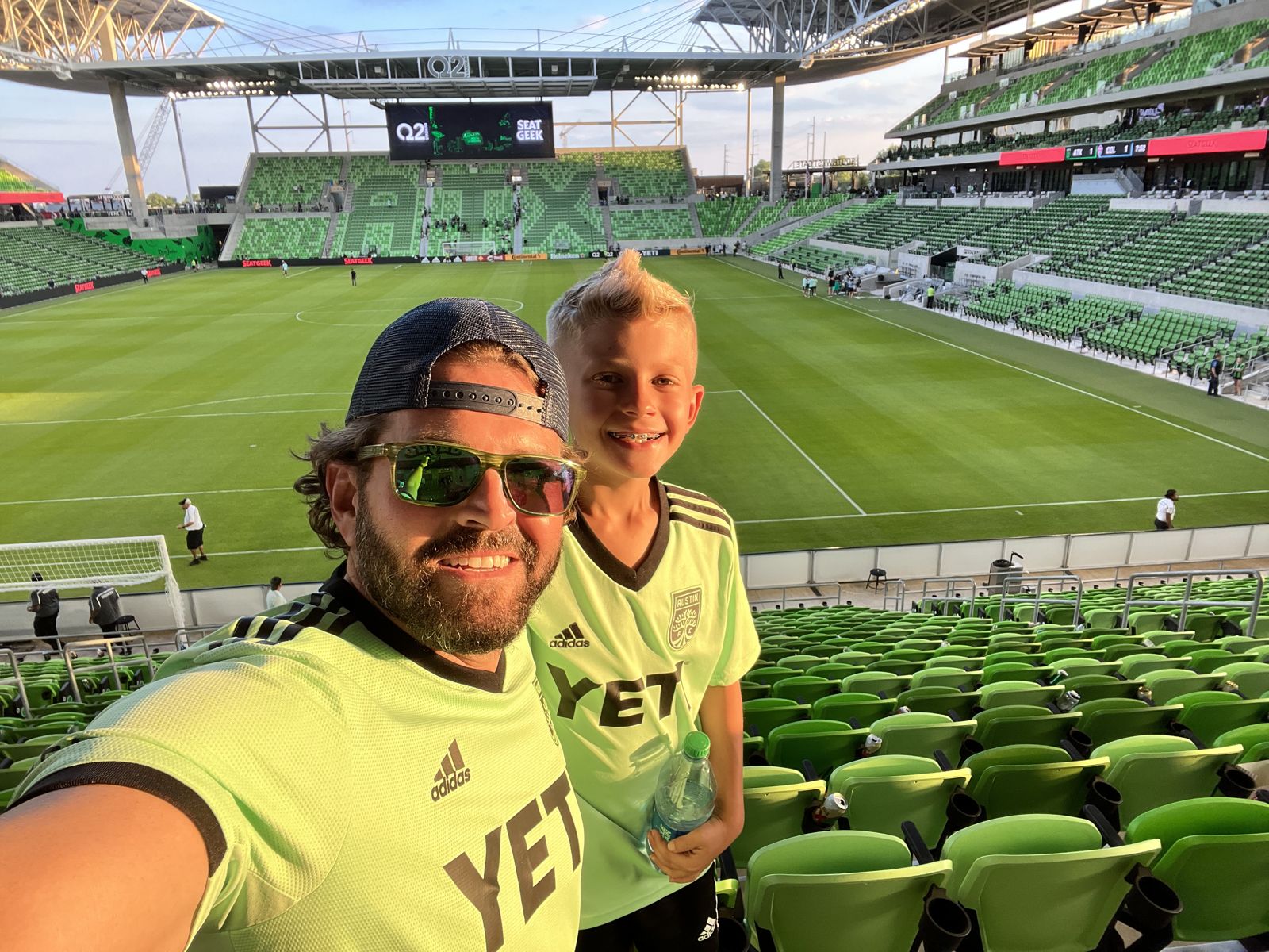 Tom and his son at an Austin FC match at Q2 Stadium